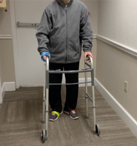 male walking with standard walker