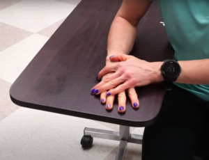 female stretching a spastic muscle on a table
