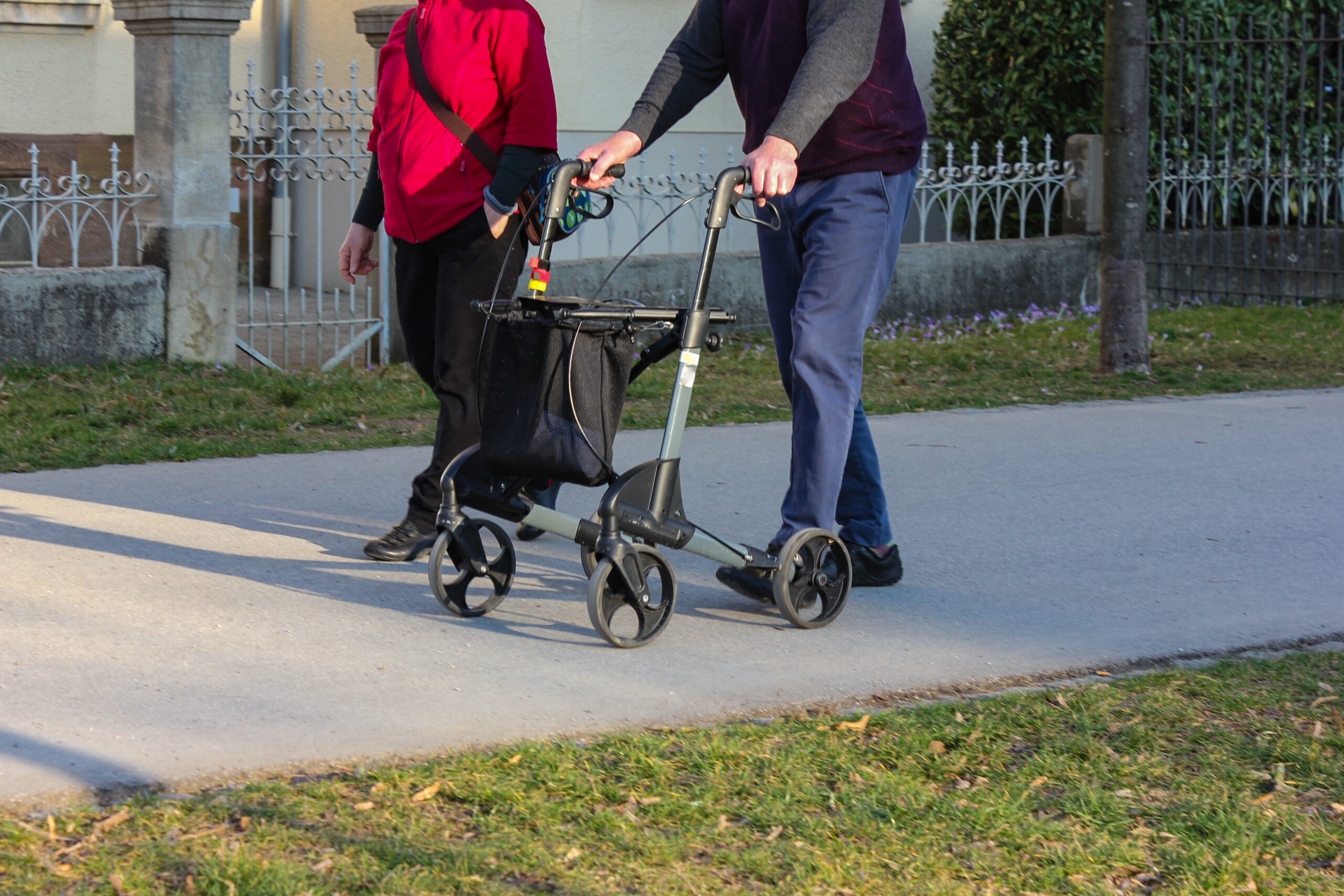 male walking with a fourwheel walker