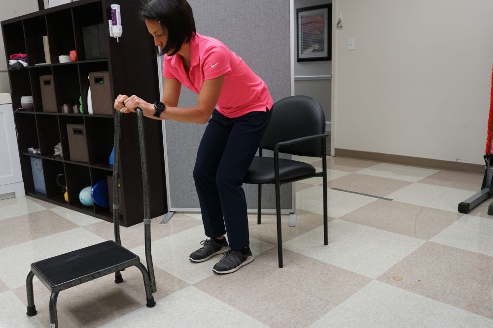 standing and balancing holding to a step stool