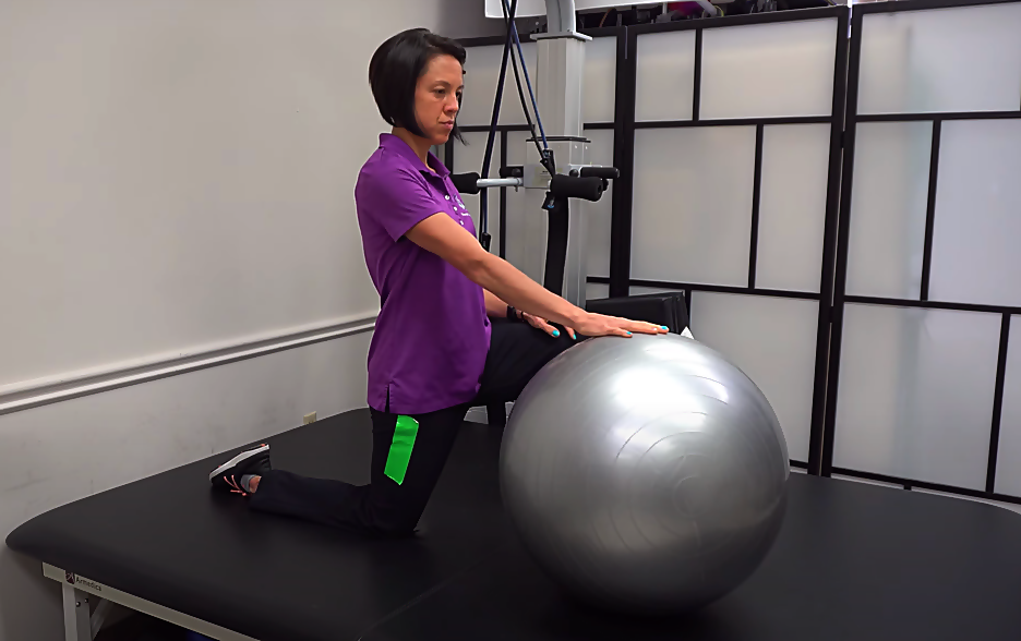 kneeling arm extension with a gym ball